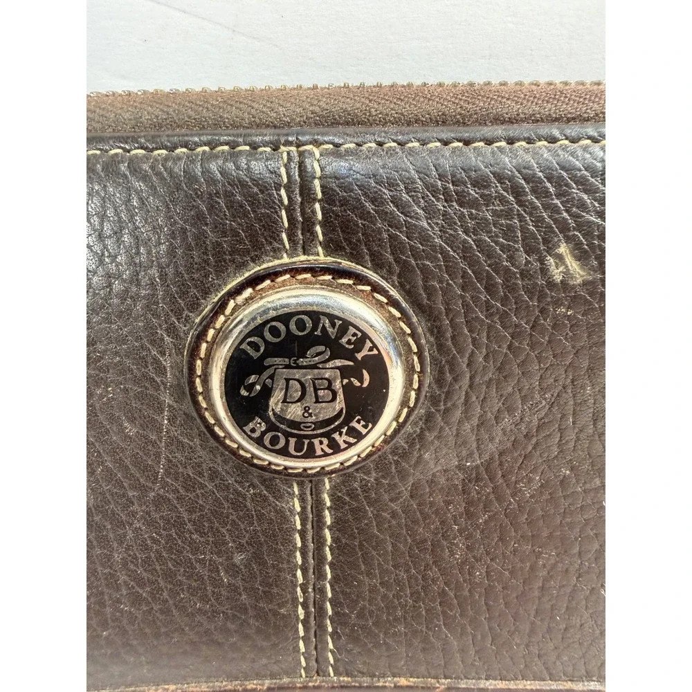 Dooney & Bourke Dark Brown Pebbled Leather Zip Around Continental Wallet Logo